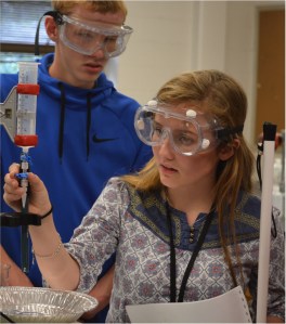 A blind student tactually exploring the lab setup for a titration.