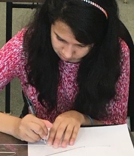 A blind student uses a notched 30/60/90 triangle to draw a vector.